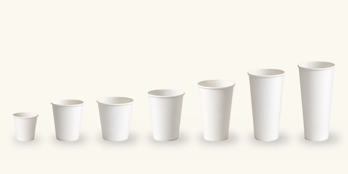 Coffee cup sizes from 4 oz to 24 oz: seven white single wall paper cups in a row, to scale